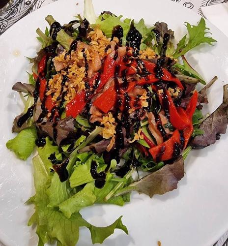 a plate of food with a salad on it at HOSTAL DON JAVIER in Ororbia