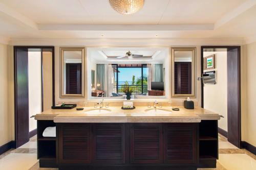 a bathroom with two sinks and a large mirror at The Westin Turtle Bay Resort & Spa, Mauritius in Balaclava