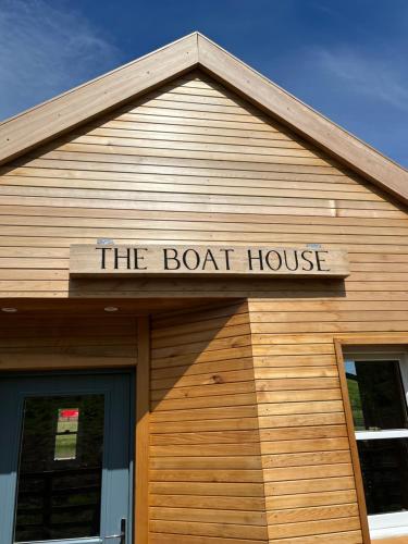 a sign on the roof of a boat house at East Learmouth Lakeside Lodges in Cornhill-on-tweed