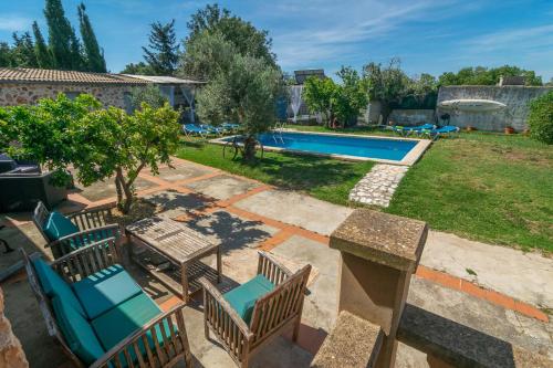 a patio with chairs and a swimming pool at Son Blau in Llucmajor