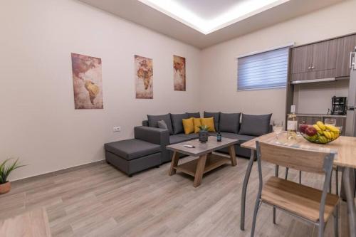 a living room with a couch and a table at Aurora apartments Room 1 in Marmari