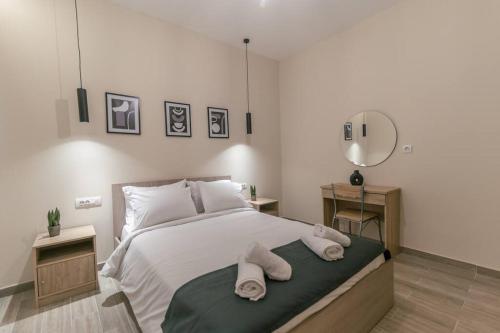 a bedroom with a large bed with towels on it at Aurora apartments Room 1 in Marmari