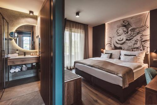 a hotel room with a bed and a bathroom at Mediterraneo Luxury Room Esztergom in Esztergom