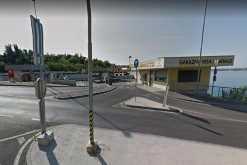 an empty street in front of a gas station at Apartma Pirano in Piran