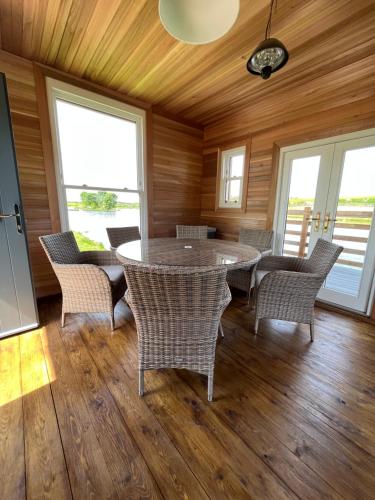 a dining room with a table and chairs at East Learmouth Lakeside Lodges - Larch Lodge in Cornhill-on-tweed