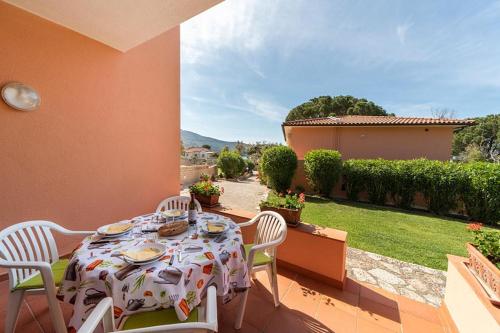 a table and chairs sitting on a patio at Villa Cecilia - Appartamenti in Procchio