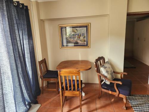 a dining room table and chairs in a room at One bedroom house in Boksburg