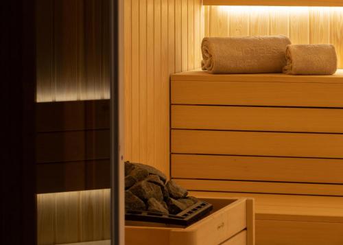 a sauna with a pile of rocks in a room at AP Dona Aninhas in Viana do Castelo