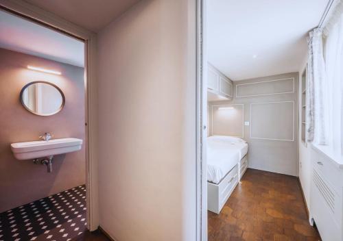 a bedroom with a bed and a sink and a mirror at CountryHouse con Piscina Privata Vicina al Centro in Florence