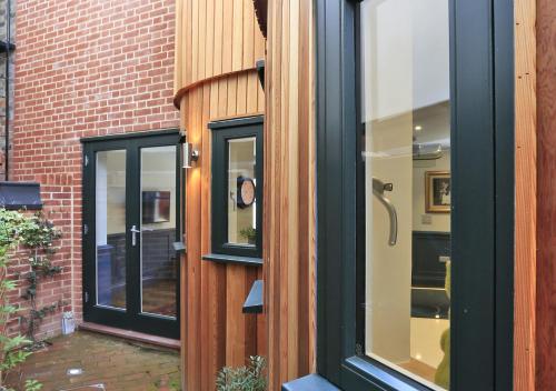 a glass door of a building with a brick wall at Zeppelin in Woodbridge