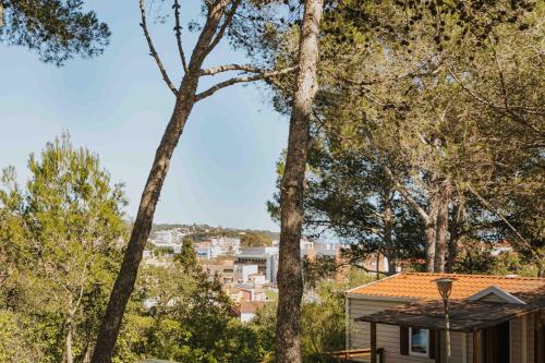a view from the backyard of a house with trees at Camping Santa Elena in Lloret de Mar
