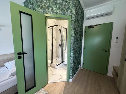 a room with green doors and a mirror at MILIA wine & event resort in Dunajský Klátov