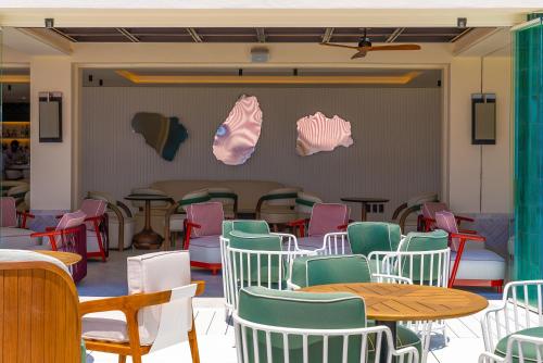 a room with colorful chairs and tables and a table at El Fuerte Marbella in Marbella