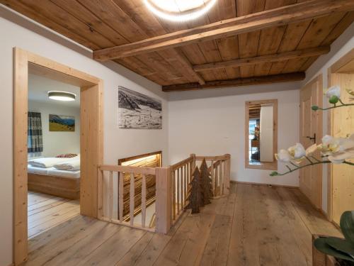 a hallway with wooden ceilings and a bed in a room at Appartement Am Hof Untertann in Kirchberg in Tirol