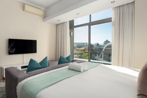 a bedroom with a large bed and a large window at Crystal Towers 212 in Cape Town