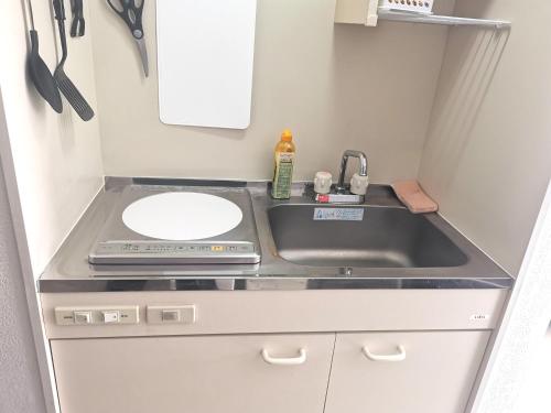 a small kitchen with a sink and a counter top at Kiki LM -- Self Check-in -- Room Number & Password is in the following email in Tokyo