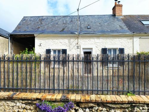 a wooden fence in front of a house at Le Blason du Poête in Mayet