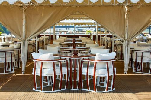 a row of tables and chairs under a tent at Sonesta St George Nile Cruise - Luxor to Aswan 4 Nights from Monday to Friday in Luxor