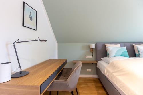 a bedroom with a bed and a desk and a bed at Windlooper 2 in Wieck