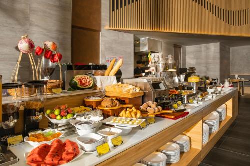 a buffet line with a lot of food on it at Estrella Boutique Hotel in Da Nang