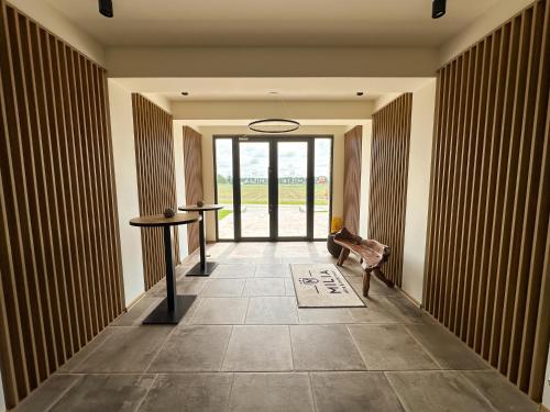 a hallway with a table and a chair in a building at MILIA wine & event resort in Dunajský Klátov