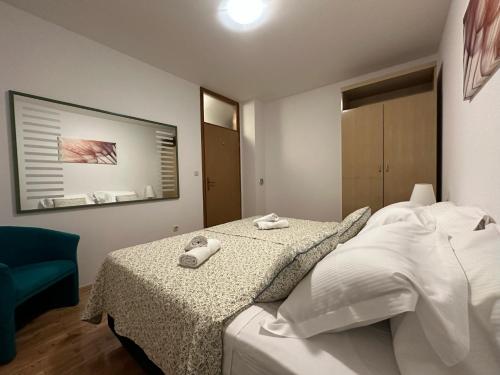 a bedroom with a bed with two towels on it at Family apartment Makarska in Makarska