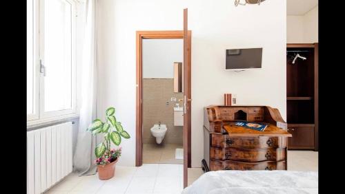 a bedroom with a door leading to a bathroom at B&B Maison Rosetta IUN-E4948 in Nuoro