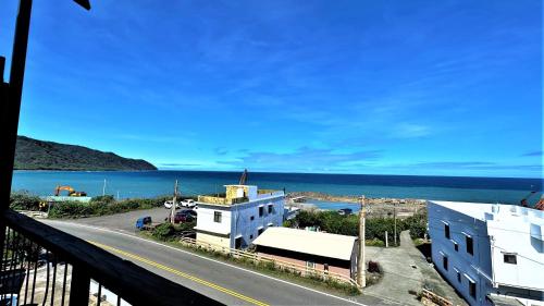 a view of the ocean from a balcony of a building at Xinghaiwan B&B in Manzhou