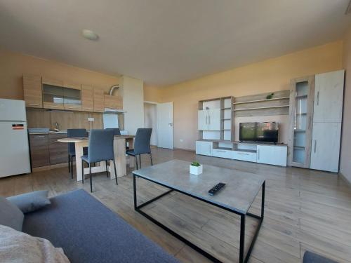 a large living room with a table and a kitchen at INTER EXPO APARTMENT in Sofia