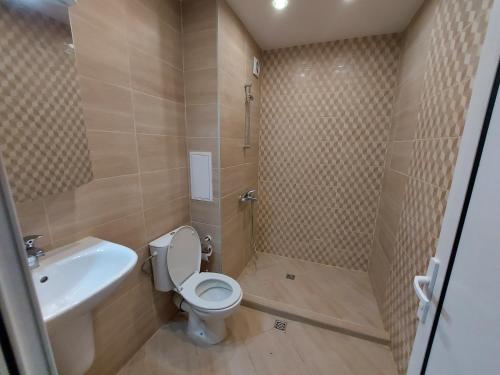 a bathroom with a toilet and a sink at INTER EXPO APARTMENT in Sofia