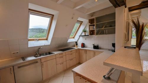 a large kitchen with a sink and a window at WOLKENFREI - ankommen und Zuhause fühlen - Apart-VL in Bad Liebenzell