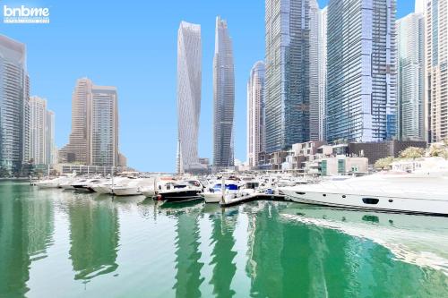 a group of boats docked in a harbor with tall buildings at bnbmehomes - Anbar Tower in Dubai