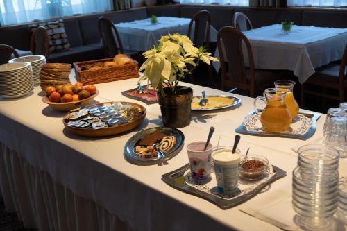 a table with plates of food on it at Gasthof Löwen in Nova Levante