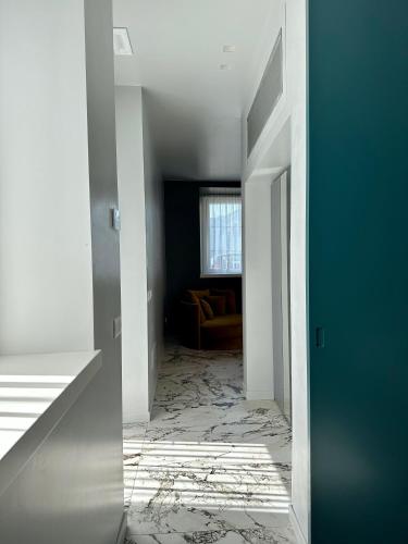 a hallway with a room with a couch in it at Vulcano Palace in Castro