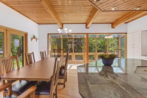 a dining room with a wooden ceiling and a table and chairs at Icicle View in Leavenworth