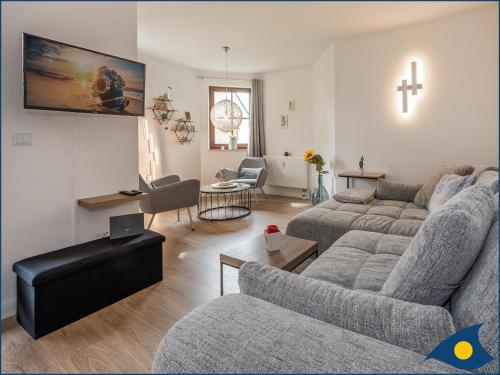 a living room with a couch and a cross on the wall at Ferienwohnung Hornig in Garz-Usedom