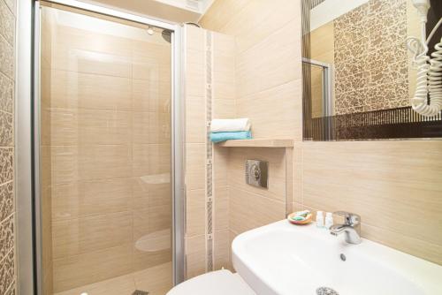 a bathroom with a shower and a sink and a toilet at Villa Mare in Łeba