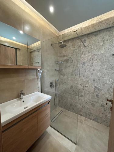 a bathroom with a sink and a shower at Georges Estates Hotel in Stoupa