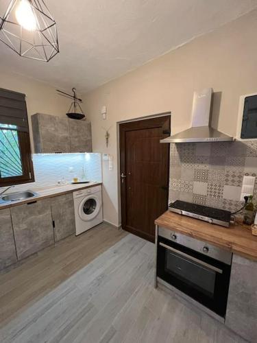 a kitchen with a sink and a stove top oven at Ideal House with Private Pool & Parking in Heraklio Town