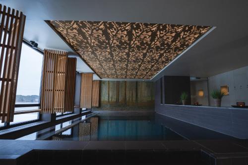 a swimming pool in a building with a ceiling at Skepparholmen Nacka in Nacka