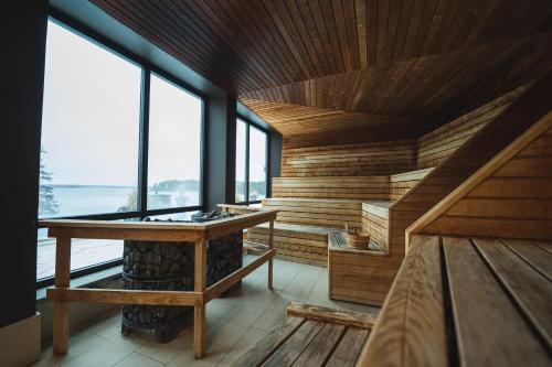 a room with a fireplace in a room with windows at Skepparholmen Nacka in Nacka