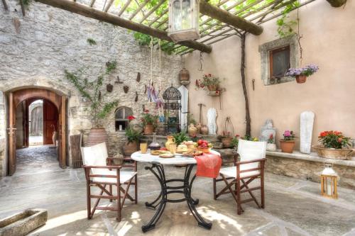 a dining room with a table and chairs at Nassibe Estate in Áyios Ioánnis