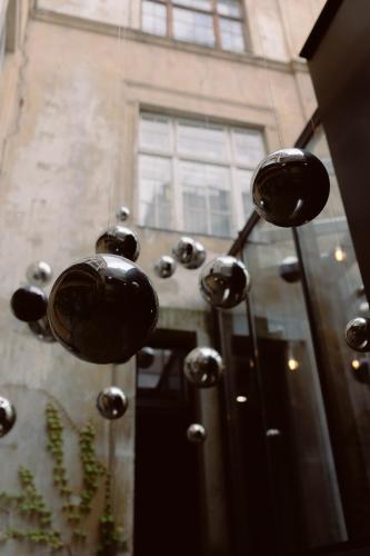 a bunch of balls hanging from a building at Gruner Hotel in Lviv