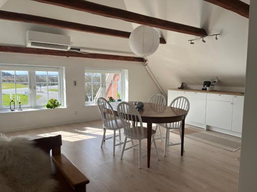 a kitchen and dining room with a table and chairs at Løkken Family Camping & Guesthouse in Løkken