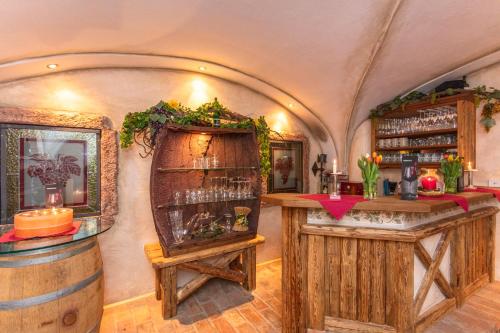 a wine tasting room with wooden barrels and a bar at Apart Hotel Alpenhof Werfenweng in Werfenweng