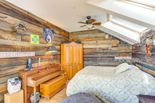 a bedroom with a bed and a wooden wall at Windham Mountain Vacation Rental about 3 Mi to Lifts! in Windham