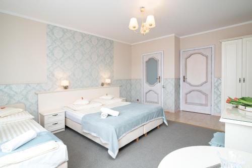 a bedroom with two beds and two mirrors at Villa Mare in Łeba