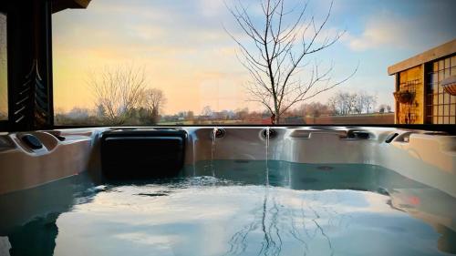 a pool of water in the middle of a building at Les Sources d'Hon - Gîte & Espace wellness in Hon-Hergies