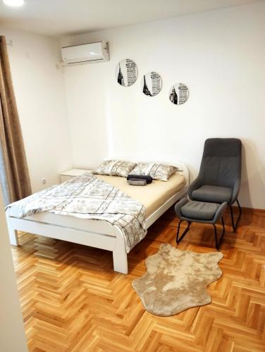 a bedroom with a bed and a chair at Apartment Dream in Trebinje