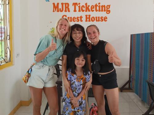 a group of people posing for a picture in a room at MJR Ticketing Guest House in Ruteng
